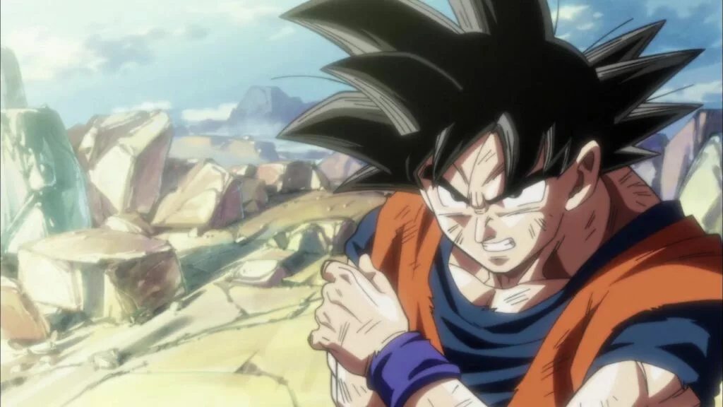 goku holding his arm after getting attacked on  dragon ball super